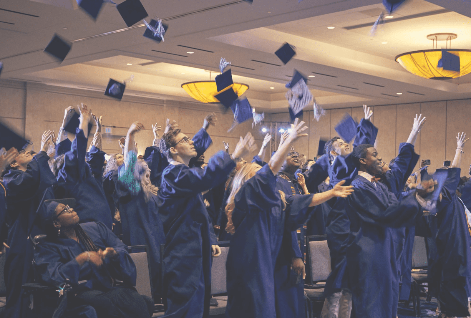 Graduation-Square-Color Graduates tossing caps into the air